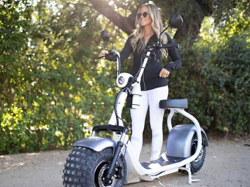 woman standing with phat scooter